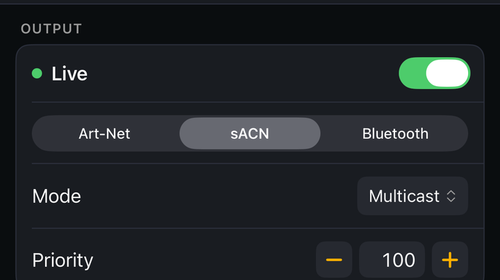 The Output section of Settings: a green Live toggle, a segmented control with Art-Net, sACN and Bluetooth (sACN selected), a Mode row set to Multicast, and a Priority stepper set to 100.